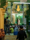 Devotees gathering wearing traditional Taqiyah to offer prayers during holy month of Ramadan or Ramzan at Local Mosque