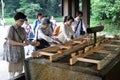 Devotees performing harai before worship at Meiji Shrine, Tokyo, Japan