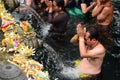 Devotees at the ritual purification in the temple pond. Tirta Empul. Tampaksiring. Gianyar regency. Bali. Indonesia