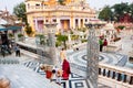 Devotees worship at the stairs to Jain temple