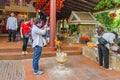 Devout buddhists practicing their rituals in the Wat Phnom in P