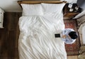 Devout woman with a bible book praying by the bed