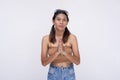 A devout young woman in modern clothing and pigtails praying the rosary. A practicing catholic teenager. Isolated on a white