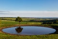 The dew pond on Ditchling Beacon in Sussex, on a sunny summer`s day