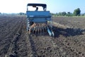 24-08-2021 Dewas, Madhya Pradesh, India, Garlic sowing by tractor, the process of planting garlic cloves in the field. The concept