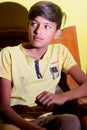 16-01-2021 Dewas, Madhya Pradesh, India. Indian boy sitting on a chair and looking at the other side