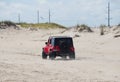 Dewey Beach, Delaware, U.S - September 3, 2022 - A red Jeep Wrangler driving on the beach