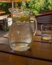 A dewy clear pitcher with a lime-lemon drink. Royalty Free Stock Photo