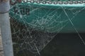 Dewy cobweb between two rowing boats in river Oude IJssel