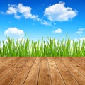 Dewy green grass with wooden planks Royalty Free Stock Photo