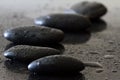 Dewy stones on black background, spa concept, body and mind, zen stone Royalty Free Stock Photo