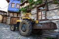 tractor in front of traditional houses