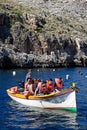 Dghajsa water taxi full of tourists, Blue Grotto.