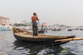 Dhaka, Bangladesh: Boatman washing himself on a wooden boat down Buriganga Ganmges River in Old Dhaka. Large white ferry Royalty Free Stock Photo