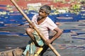 Dhaka, Bangladesh, February 24 2017: Portrait of a Rower in his wooden boat on the river Royalty Free Stock Photo