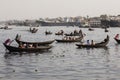 Dhaka, Bangladesh, February 24 2017: Small rowboats serve as taxi between the two river banks
