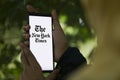 Dhaka, Bangladesh - 09 January 2024: Hands holding a smartphone with The New York Times logo on the screen. The New York Times is