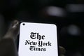 Dhaka, Bangladesh - 09 January 2024: Hands holding a smartphone with The New York Times logo on the screen. The New York Times is