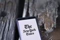 Dhaka, Bangladesh - 09 January 2024: Hands holding a smartphone with The New York Times logo on the screen. The New York Times is