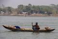 Dhaka, Bangladesh - march-12-2023: Rural fisherman with a small wooden boat fishing on the river. Scenic rural life closeup with Royalty Free Stock Photo