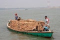 Dhaka, Bangladesh - march-12-2023: Workers transporting bricks with a water vessel on the river. Small wooden trawler