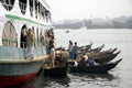 Dhaka, Bangladesh: Small boats moored alongside a ship on the river at Sadarghat in Dhaka Royalty Free Stock Photo