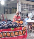 Dhaka, Bangladesh - 11.07.2021: Small helpless businessman selling shoes in an empty railway station during corona lock down in