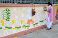 Art institute student painting a colorful wal