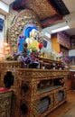 DHARAMSALA, INDIA - 2019: Golden statue of Buddha with blue hair on the Altair in temple of the Dalai Lama.