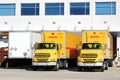 DHL trucks and trailers parked at a warehouse