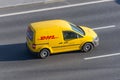 DHL world wide courier company delivery small cargo car on the highway city. Russia, Saint-Petersburg 07 may 2020 Royalty Free Stock Photo