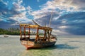 Wooden fisherman boats on sandy beach with blue water background, Zanzibar, Tanzania Royalty Free Stock Photo