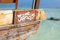 Wooden fisherman boats on sandy beach with blue water background, Zanzibar, Tanzania Royalty Free Stock Photo