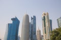 A dhow passes beneath some of the most massive buildings in Doha, Qatar, shortly before sunset. Royalty Free Stock Photo