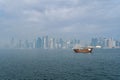 A traditional dhow in Doha, Qatar with the city`s modern skyline in the background. Royalty Free Stock Photo