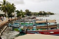Dhows and boats moored at shore against buildings in Shela Beach, Lamu Island, Kenya