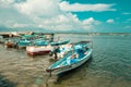 Dhows and boats moored at shore against buildings in Shela Beach, Lamu Island, Kenya