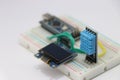 DHT11 or Temperature and humidity sensor with OLED display circuit on a breadboard run by some microcontroller on the background Royalty Free Stock Photo