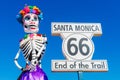 Dia De Los Muertos, The Day Of The Dead, Colorful Sculpture And Route 66 End Of The Trail Sign, A Historical Marker By The Santa