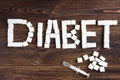 Diabet concept. Sugar and insulin in syringe on dark wooden background
