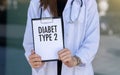 Diabet Type 2 text with stethoscope and pills on hands doctor