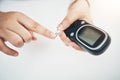 Diabetes, hands of black woman and blood test strip on finger, healthcare and medicine in home. Health, innovation and Royalty Free Stock Photo