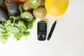 Diabetes monitor, diet and healthy food eating nutritional concept with clean fruits and vegetables with diabetic measuring tool Royalty Free Stock Photo