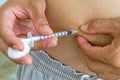 Diabetes patient gets an insulin injection in abdomen area over