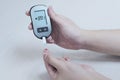 Diabetes patients use a sugar glucose meter to measure their blood glucose levels at home Royalty Free Stock Photo