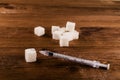 Diabetes is terrible disease. A lot of sugar cubes with syringe