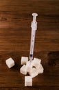 Diabetes is terrible disease. A lot of sugar cubes with syringe