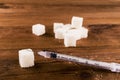 Diabetes is terrible disease. A lot of sugar cubes with syringe