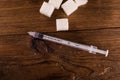 Diabetes is terrible disease. A lot of sugar cubes with syringe