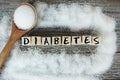 Diabetes word on wooden letters with crystalized white sugar as frame Royalty Free Stock Photo